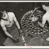 Packing filled cans into cooking basket. Canning factory, Sun Prairie, Wisconsin