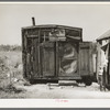 Tarpaper dwelling of man living in abandoned lumber camp, Gemmel, Minnesota