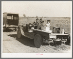 Children of Indian blueberry pickers in truck. Note boxes for blueberries and clothes, near Littlefork, Minnesota