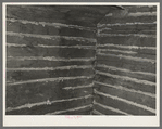 Corner of interior of old log cabin showing detail of construction and hand-hewn logs. Near Gheen, Minnesota