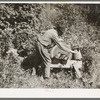 William Besson, old iron ore prospector, grinding an axe near Winton, Minnesota