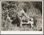 William Besson, old iron ore prospector, grinding an axe near Winton, Minnesota