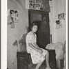 Mexican girl sitting in front of bedspring which formed partition between the family's living quarters and those of a man boarder. San Antonio, Texas, corral