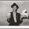 Mexican pecan workers union official displaying relief supplies which are supposed to feed a family of three for two weeks. The articles shown are beans and butter. San Antonio, Texas