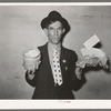 Mexican pecan workers union official displaying relief supplies which are supposed to feed a family of three for two weeks. The articles shown are beans and butter. San Antonio, Texas