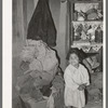 Mexican child in corner of living room. San Antonio, Texas