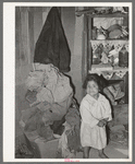 Mexican child in corner of living room. San Antonio, Texas