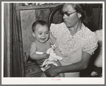 Mexican mother with child with impetigo. Crystal City, Texas