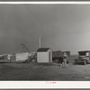 Pump house on farm. The camp of a brother who came to El Indio to look over the land before buying is also shown. Texas