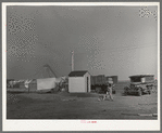 Pump house on farm. The camp of a brother who came to El Indio to look over the land before buying is also shown. Texas