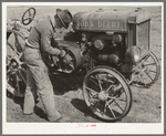 Son of pioneer at El Indio, Texas, repairing clutch on tractor