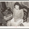 Mexican woman sitting in front of stove. San Antonio, Texas