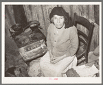 Mexican woman sitting in front of stove. San Antonio, Texas