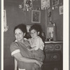Mexican mother and child in front of shrine in corner of room. San Antonio, Texas