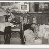 Mexican woman resting on bed in her home. San Antonio, Texas