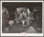 Wives of vegetable peddlers sometimes accompany their husbands to the early morning market. San Antonio, Texas