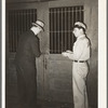 Unlocking the door of a commission house opposite the vegetable market. San Antonio, Texas