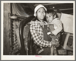 Mexican mother and child in shack home. San Antonio, Texas
