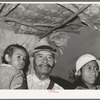 Mexican father, daughter and grandchild in shack home. San Antonio, Texas