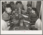 Mexican pecan shellers removing nuts from shells, non-union plant. San Antonio, Texas