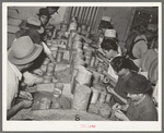 Mexican pecan shellers removing meats from shell. Union plant. San Antonio, Texas