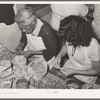 Removing the meats from cracked pecans. Non-union pecan shelling plant. San Antonio, Texas