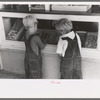 Little boys deciding what kind of candy they want to buy, Caldwell, Idaho