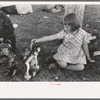 Little girl plays with prizes won at concession, Fourth of July, Vale, Oregon