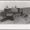 Gasoline, fuel oil and lubricants are carried to tractor and combine in wheat field. Eureka Flats, Walla Walla County, Washington