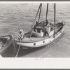 Fishing boat tied up at docks of the Columbia River Packing Association, Astoria, Oregon