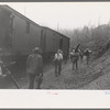 Lumberjacks get off the "crummies" when they arrive in the woods. Long Bell Lumber Company, Cowlitz County, Washington
