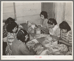 Mexican women separating meat from shells. Pecan shelling plant. San Antonio, Texas