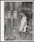 Daughter of Negro sharecropper drinking from hollow gourd. Near Marshall, Texas