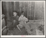 Two children of family living on relief near Jefferson, Texas. These children did not attend school because of lack of warm clothes and indifference of mother who was sick with pellagra. Note baby's cradle