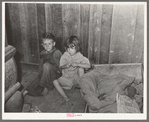 Two children of family living on relief near Jefferson, Texas. These children did not attend school because of lack of warm clothes and indifference of mother who was sick with pellagra. Note baby's cradle