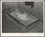 Baby of family living on relief. Notice the homemade cradle. Near Jefferson, Texas. Housing conditions in this section are particularly bad