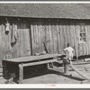 Child walking up improvised stairway on back of his home near Jefferson, Texas. Housing conditions are bad throughout this section