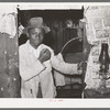 Young Negro strawberry picker in doorway. Near Hammond, Louisiana