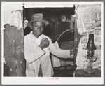 Young Negro strawberry picker in doorway. Near Hammond, Louisiana