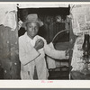 Young Negro strawberry picker in doorway. Near Hammond, Louisiana