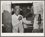 Young Negro strawberry picker in doorway. Near Hammond, Louisiana