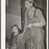 Ex-farmer and his son now living on relief. Outskirts of Jefferson, Texas