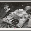 White migrant berry picker and son eating dinner near Hammond, Louisiana