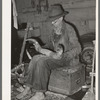 White migrant worker fitting horn onto wooden base near Hammond, Louisiana