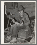 White migrant worker fitting horn onto wooden base near Hammond, Louisiana