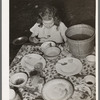 Daughter of white migrant berry picker eating dinner. Hammond, Louisiana