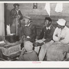 Group of Negroes around stove on a cold day in the strawberry picking season. Near Independence, Louisiana