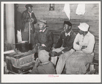 Group of Negroes around stove on a cold day in the strawberry picking season. Near Independence, Louisiana
