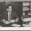 Department store owner at desk. San Augustine, Texas