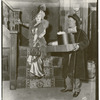 Mae West and unidentified actor (holding boxes) in the stage production Diamond Lil